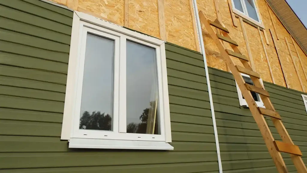 Olive vinyl siding installation half-completed by Stockton Swift Fix, capturing durable upgrades on a Stockton CA house.